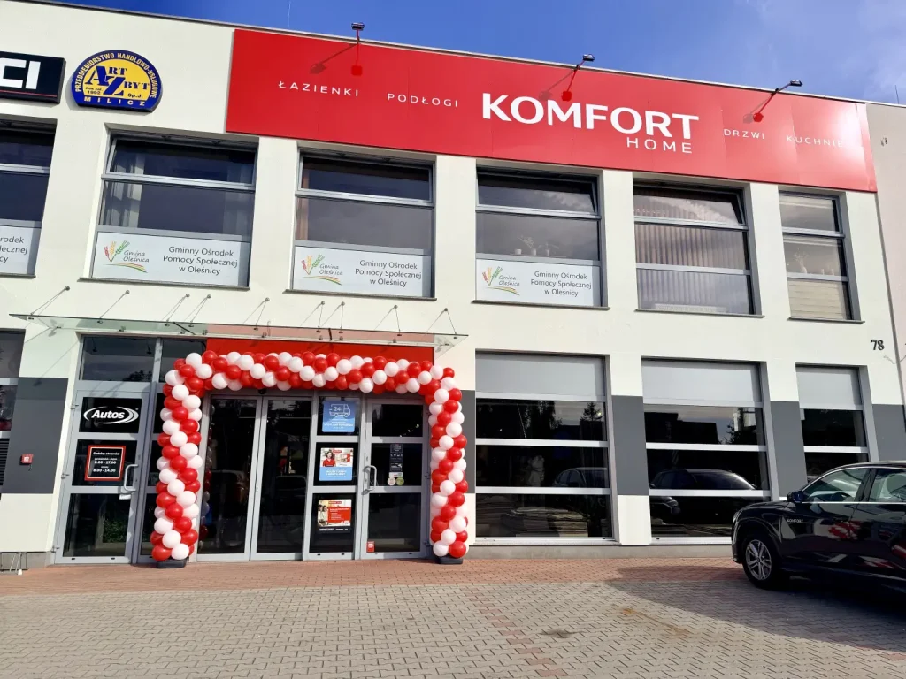 Biało-czerwona brama z balonów przed głównym wejściem do sklepu Komfort w Oleśnicy